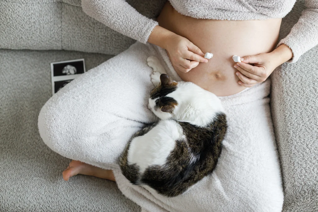 pregnant-woman-holding-earphones-at-baby-bump-with-2025-06-06-01-07-37-utc-scaled